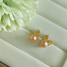 Load image into Gallery viewer, Peachy Pink Freshwater pearls set in CZ delicate ribbon style studs (Gold)