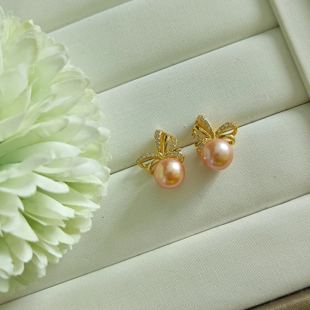 Peachy Pink Freshwater pearls set in CZ delicate ribbon style studs (Gold)